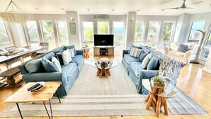 A spacious living room with two sofas, a coffee table, and a TV.