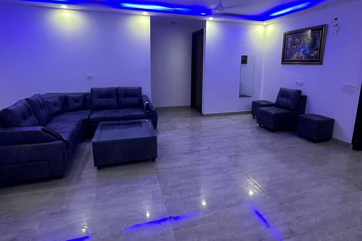 A modern living room with a sectional sofa, a coffee table, and a small side table.
