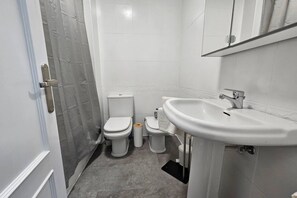 A bathroom with a toilet, bidet, and sink. - C12A01 Charming home with a pool and garage by R2R (Suances)