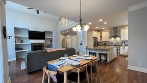 A modern kitchen with a dining area, built-in appliances, and a cozy seating area. - Amythist (Flagstaff)