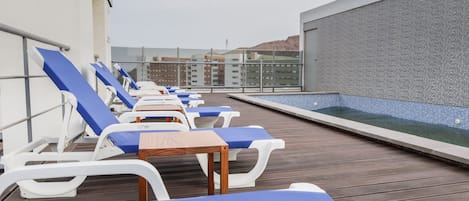 Outdoor pool, open 6:00 AM to 10:00 PM, pool umbrellas, pool loungers