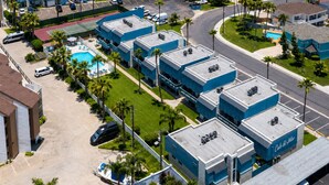 A coastal hotel with multiple-story buildings, a swimming pool, and a view of the ocean. - Las Brisas on the Bay Unit 116 (South Padre Island)