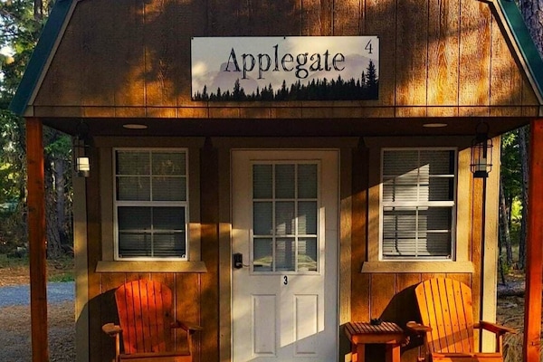 This cozy cabin, nestled among the towering pines and firs, offers a rustic charm and a serene retreat from the hustle and bustle of everyday life. The place features a queen-sized bed with cozy blankets, Smart TV, a Keurig Coffee maker, Mini-fridge, a microwave, air conditioning, and heat.