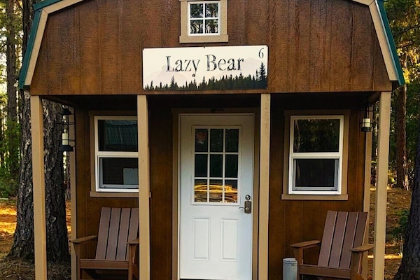 This cozy cabin, nestled among the towering pines and firs, offers a rustic charm and a serene retreat from the hustle and bustle of everyday life. The place features a luxury king-sized bed with cozy blankets, Smart TV, a Keurig Coffee maker, Mini-fridge, a microwave, air conditioning, and heat.