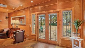 A wooden interior with a stone floor, leather furniture, and a large mirror. - King (Flagstaff)