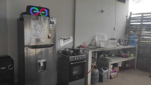 A compact kitchen with a refrigerator, stove, and sink.