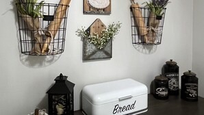 A kitchen counter with a white bread box labeled "Bread," a sign saying "Life is Beautiful," and decorative items including a pumpkin and a sign that says "Give thanks." - "Relaxing Retreat"  7 Night Discount~No Stairs~Indoor Pool~Golf~Trout~Pickleball (Branson)
