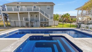 A rectangular swimming pool with a black outline, surrounded by a concrete deck. - Long Bay Duplex Lower Unit by the Beach (Surfside Beach)