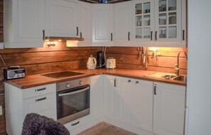 Fridge, dishwasher, coffee/tea maker, cookware/dishes/utensils