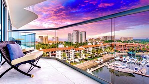 A balcony with a view of a marina and buildings.