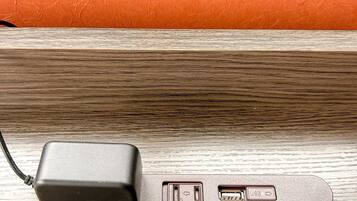 A power adapter with USB ports on a wooden surface.