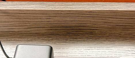 A power adapter with USB ports on a wooden surface.