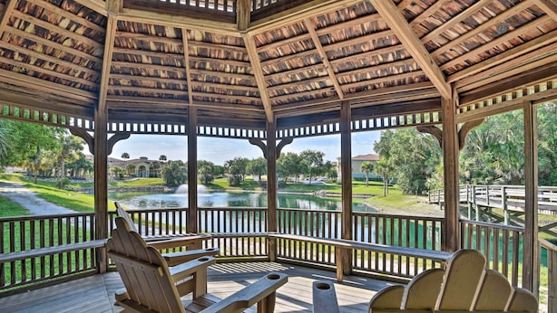Un gazebo in legno con vista su un lago e un campo da golf.