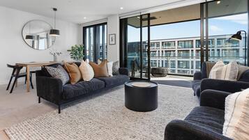 Deluxe Apartment | Living area | 55-inch Smart TV with digital channels, Netflix, heated floors