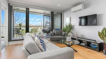 Deluxe Apartment | Living area | 55-inch Smart TV with digital channels, Netflix, streaming services