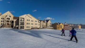 A ski resort with multi-story buildings and a snow-covered slope.