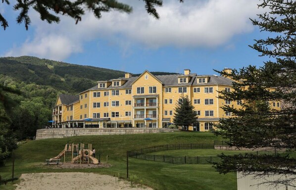 Situated on a grassy slope, this hotel offers a serene setting with a playground nearby.