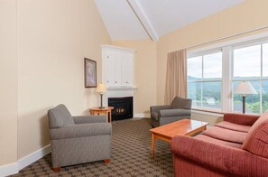 Relax by the fireplace in a spacious living room with a scenic view.