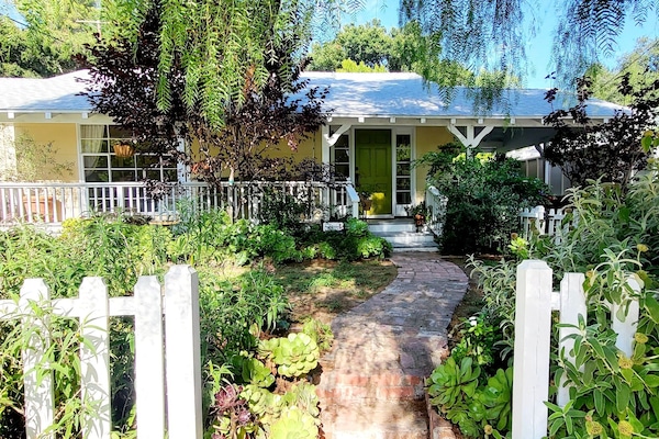 beautiful gardens, tree-lined street, walkable neighborhood.
