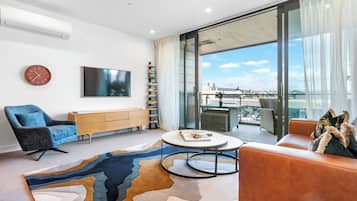 Deluxe Apartment | Living room | 50-inch Smart TV with digital channels, Netflix, streaming services