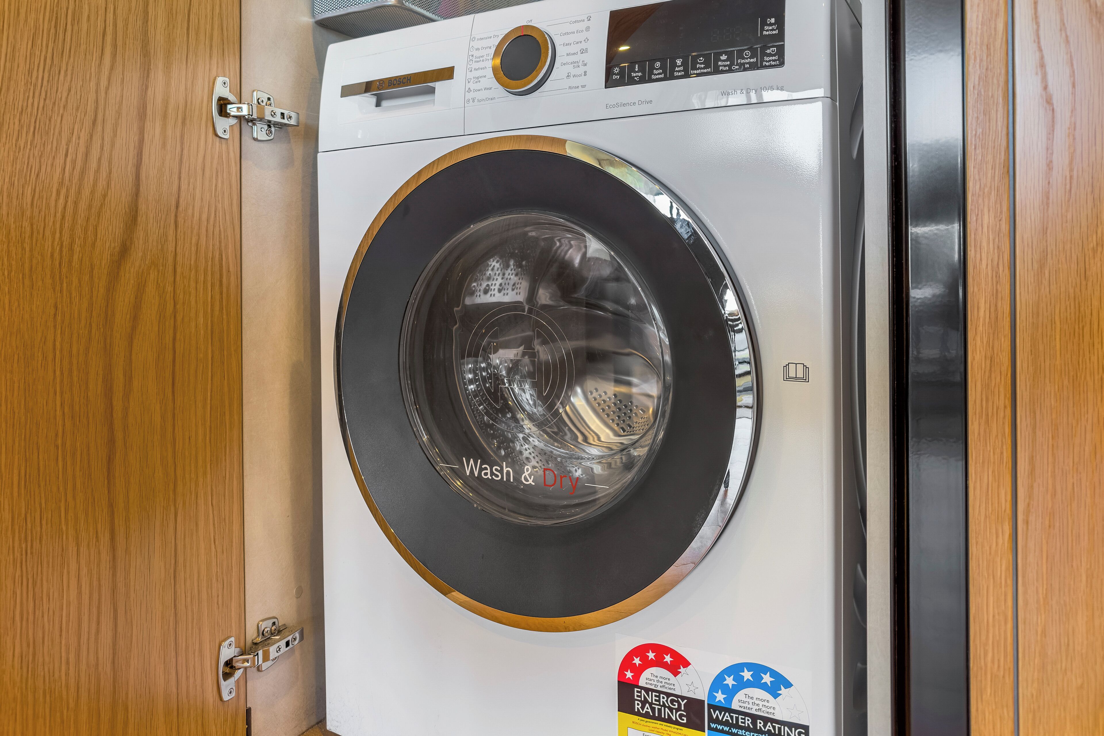 A front-loading washing machine with a control panel and a door.