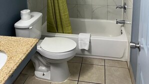 A bathroom with a toilet, sink, and bathtub. - Holiday Motel (Jeffersonville)