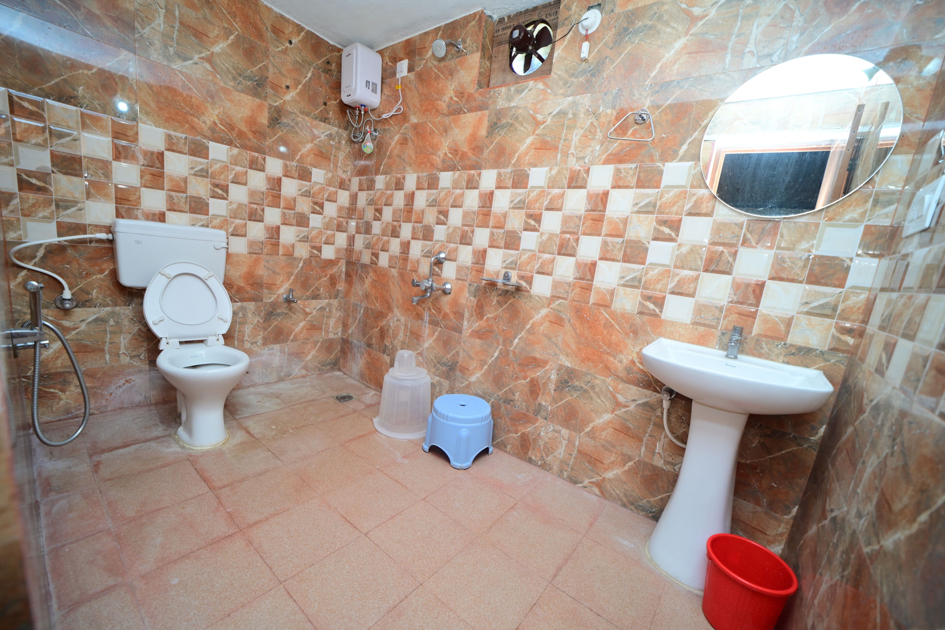 A bathroom with a toilet, sink, and shower.