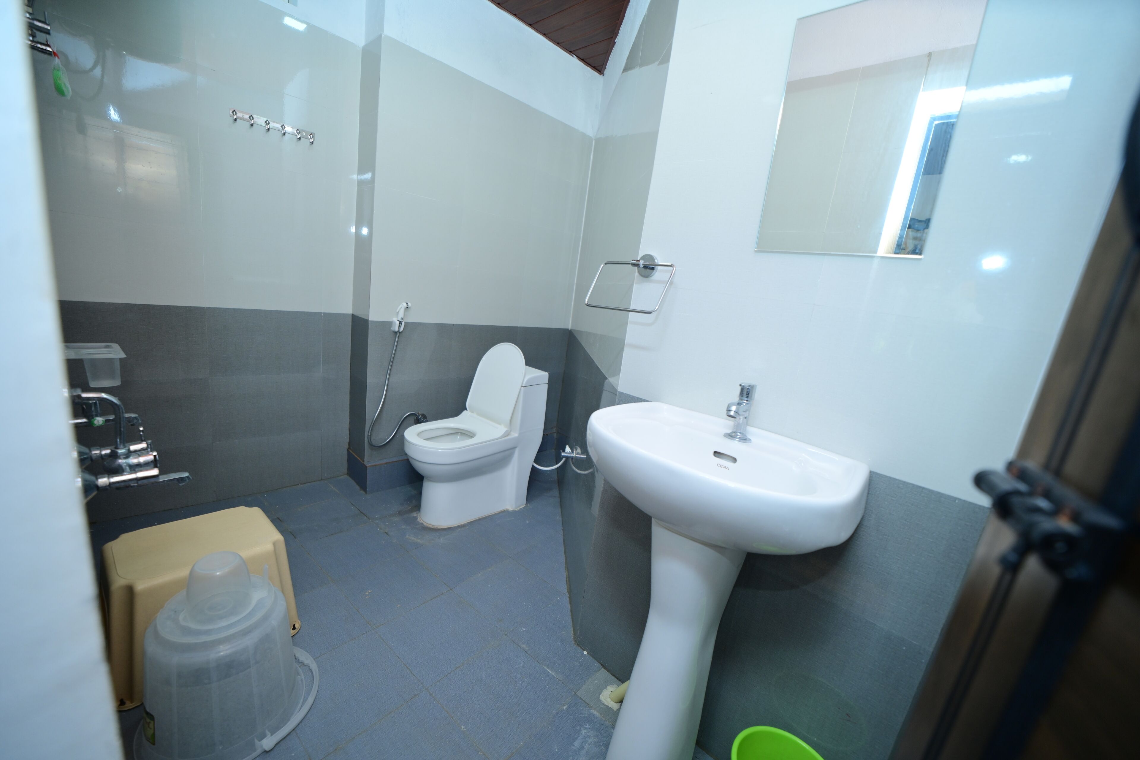 A bathroom with a toilet, sink, and shower.