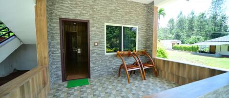 A room with a tiled floor, a wooden bench, a window, and a door.