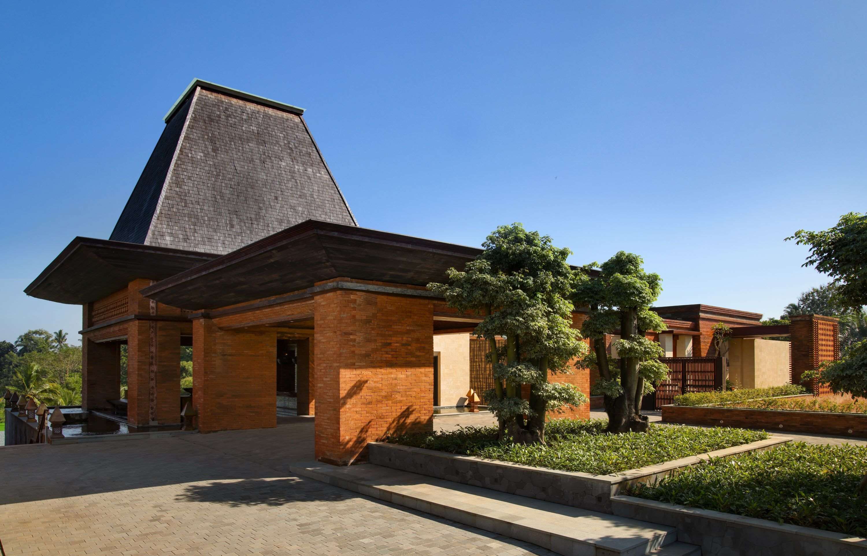 A building with a prominent triangular roof and a brick facade.