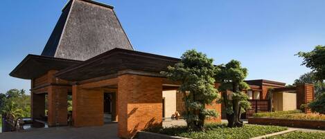 A building with a prominent triangular roof and a brick facade.