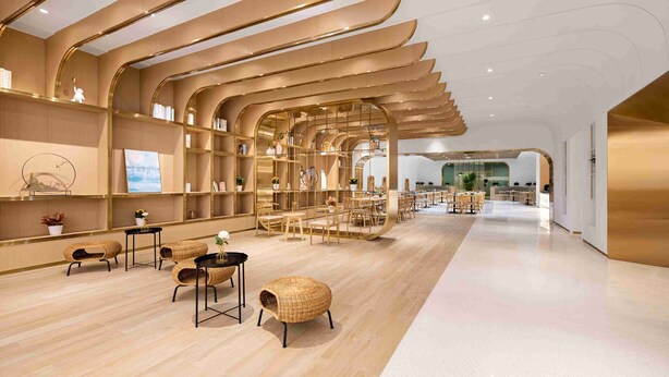 A modern interior with curved wooden shelves, wicker furniture, and a clean, minimalist design. - Quantum Inn East Railway Station (Hangzhou)