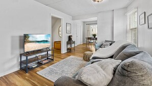 A modern living room with a flat-screen TV, a grey sofa, and a wooden coffee table. - Pattison`s Peaceful Retreat (Superior)