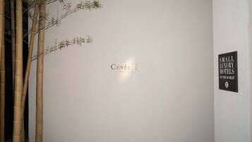 A wall with the text 'Cuvee J2' and a sign stating 'SMALL LUXURY HOTELS OF THE WORLD'.