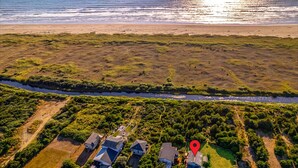 An aerial view of a coastal residential area with houses, a river, and a beach. - Brathouse By The Sea (Copalis Beach)