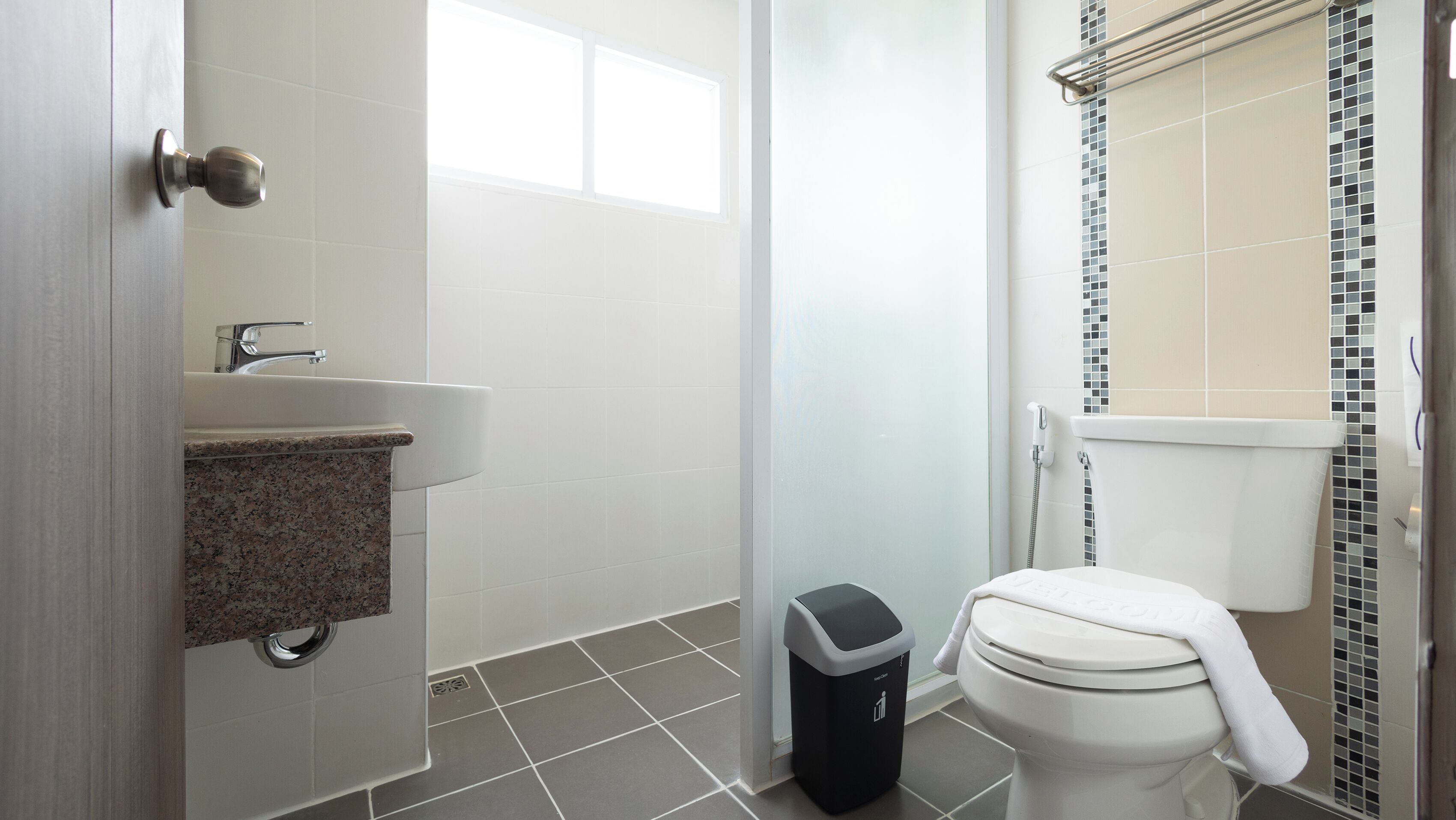 A bathroom with a sink, toilet, and shower.
