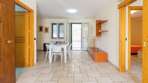 A spacious kitchen with a dining table, chairs, and a built-in oven.