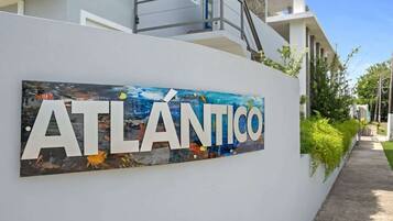 A building with a sign that reads "ATLÁNTICO" and a modern architectural design.