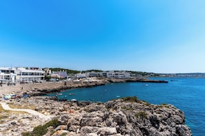 A coastal town with rocky terrain, a beach, and buildings along the shore. - 3576 Appartamenti Panorama - PP by Barbarhouse (Nardò)