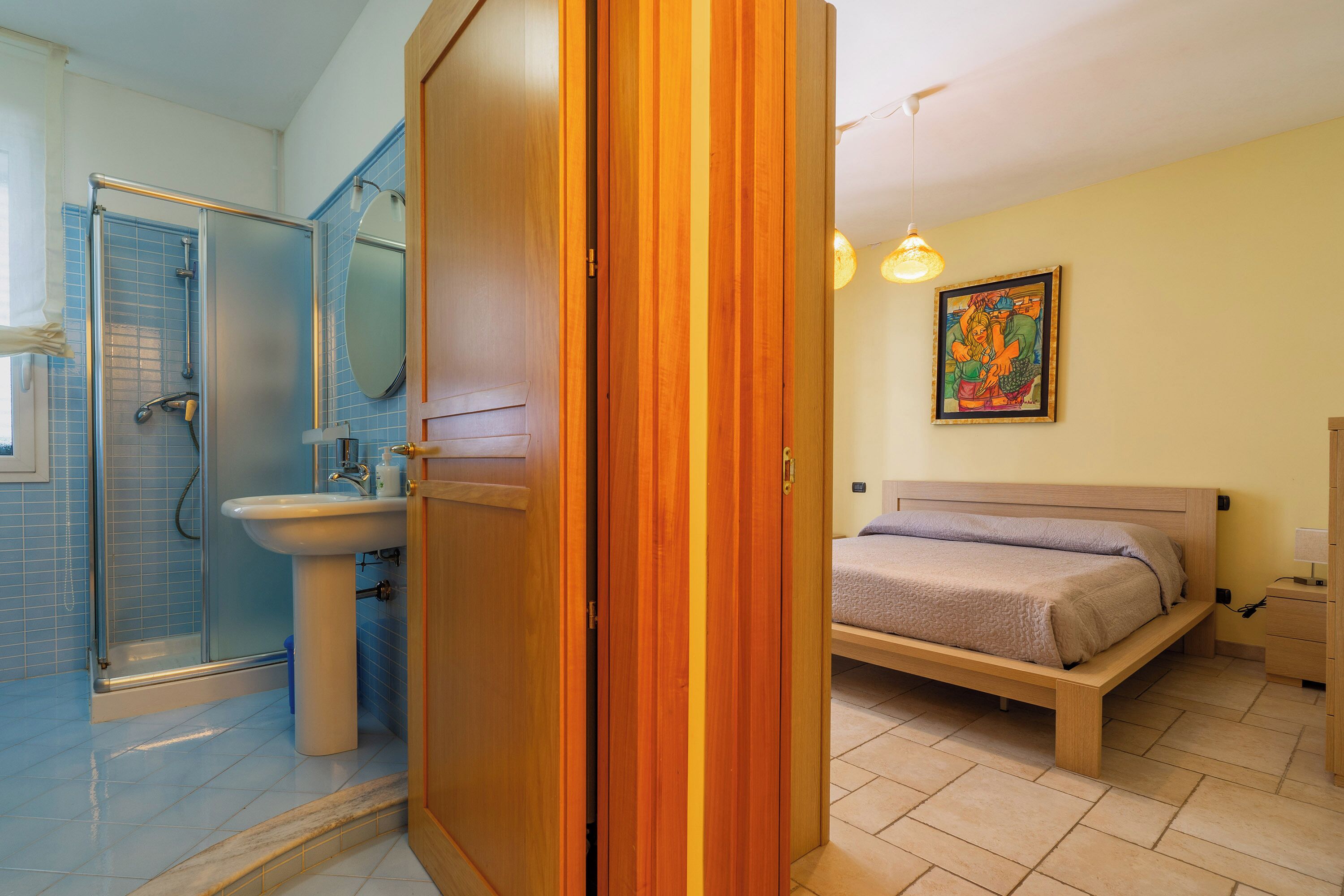 A bathroom with a shower, sink, and toilet.