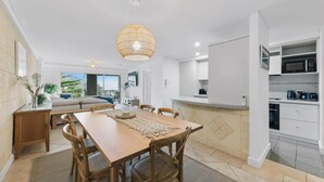 A modern kitchen with white cabinets, a built-in oven, and a microwave. - Apartment M204 - coastal and comfortable! (Scarborough)