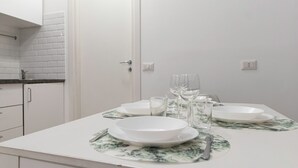 A clean, white bathroom with a sink and mirror. There are white cabinets and a tiled backsplash. - Italianway - Orti 5 (Milan)
