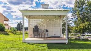 A gazebo with a covered seating area, a fan, and a grill. - Dixieland Delight at River Rocks Plantation (Guntersville)