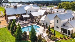 A residential area with multiple houses, a swimming pool, and a fenced yard. - Dixieland Delight at River Rocks Plantation (Guntersville)