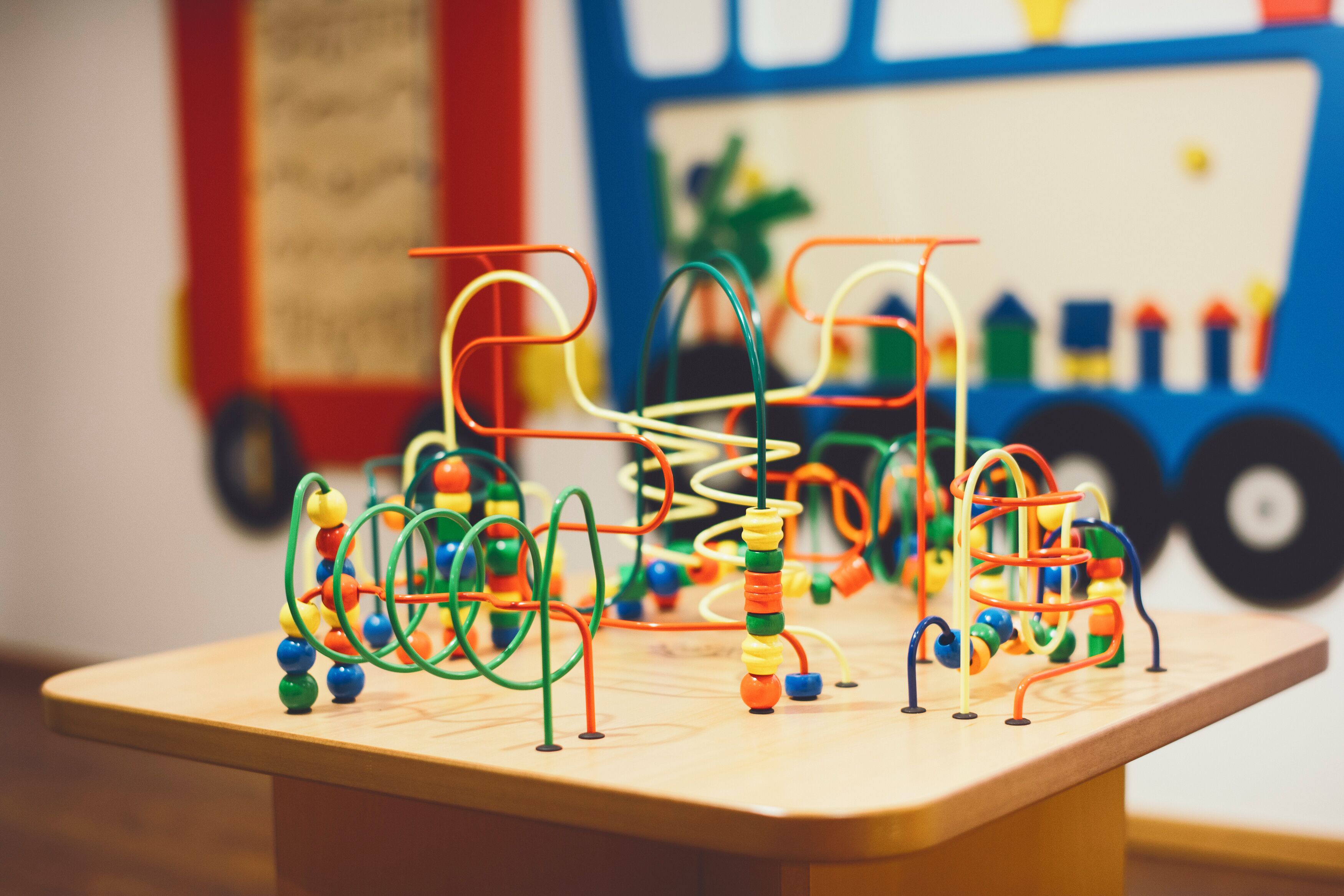 A wooden table with colorful abacus toys.