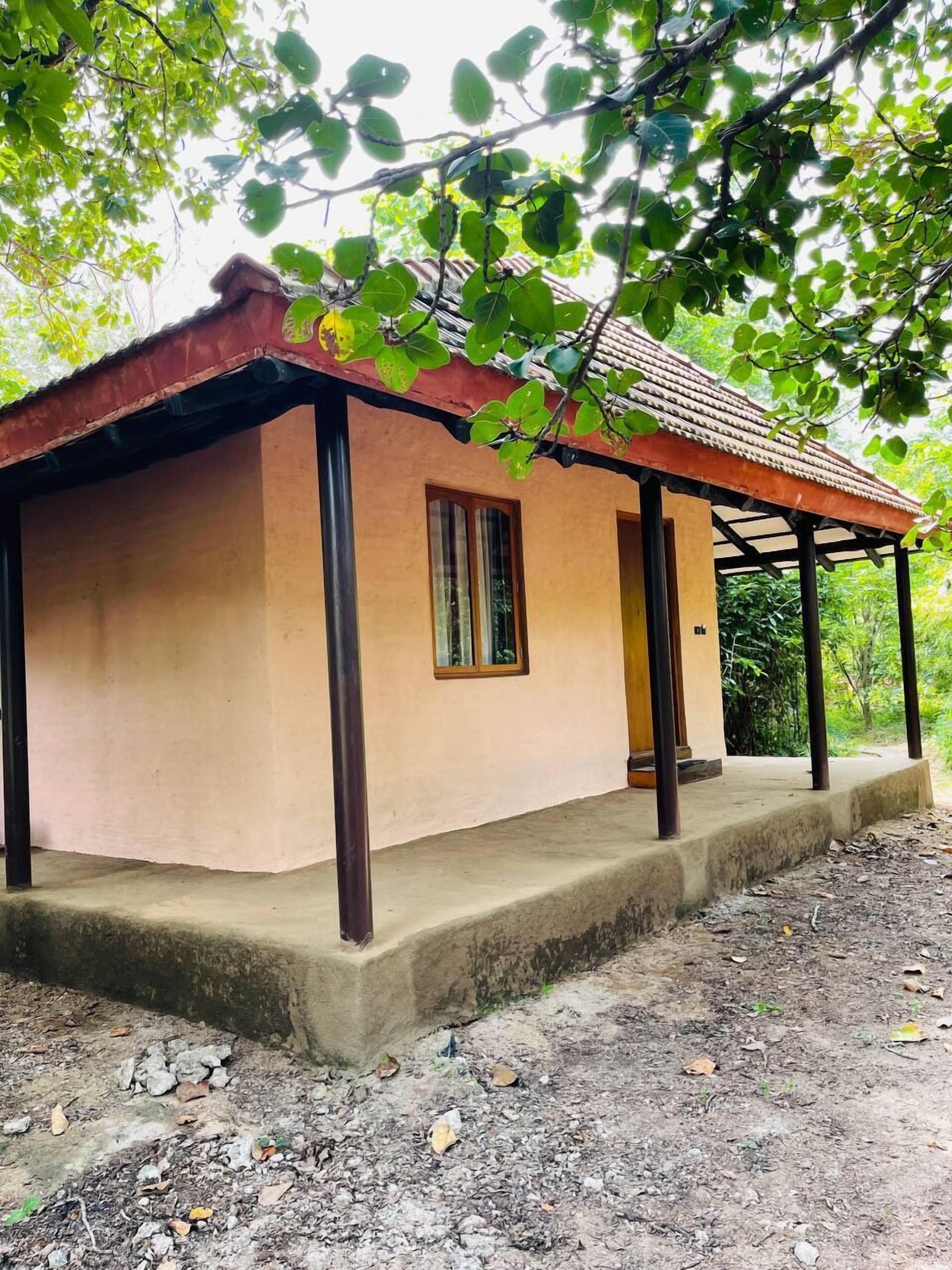A small, single-story building with a sloped roof and a porch area.