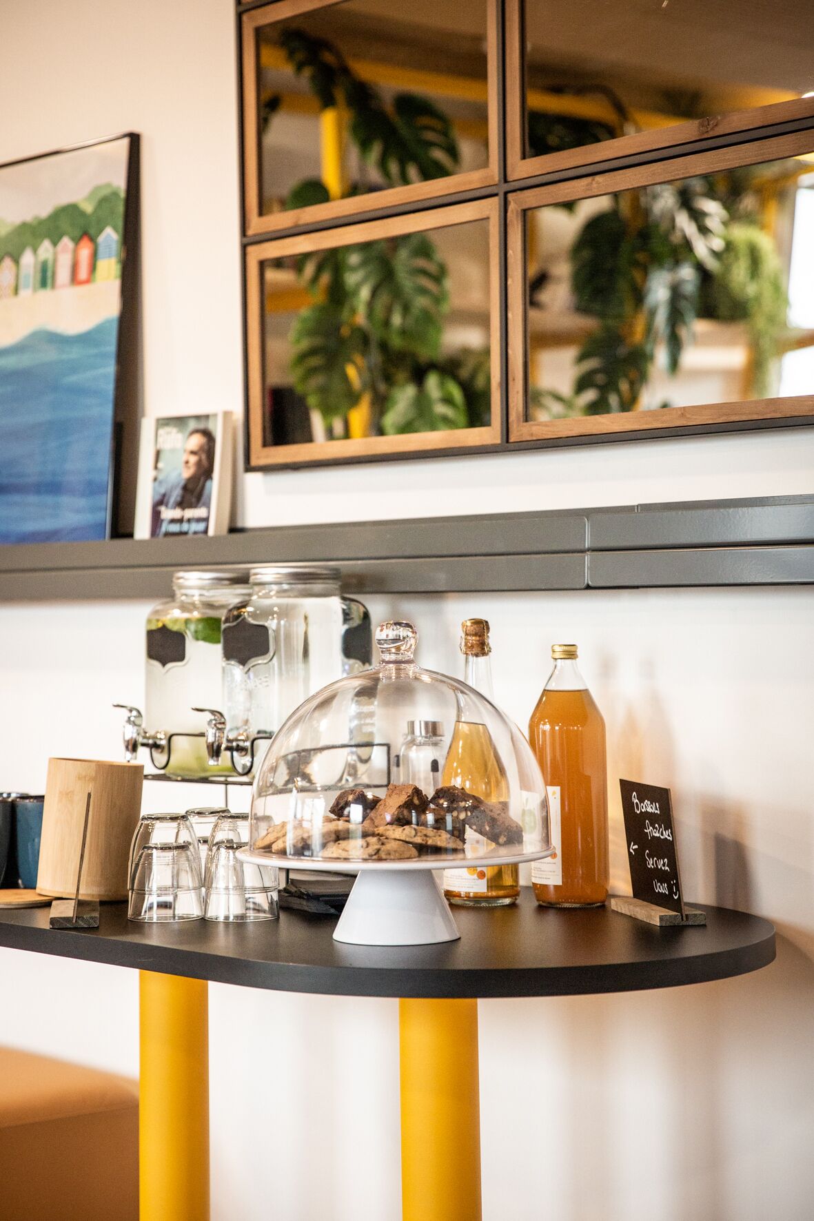 A bar area with a glass display case, a bottle of amber liquid, and a chalkboard menu.