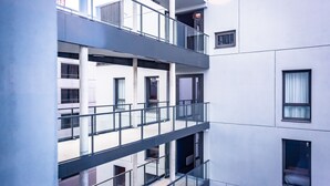 A multi-story building with balconies, large windows, and a modern architectural style. - Jost Hotel Le Havre Gare (Le Havre)