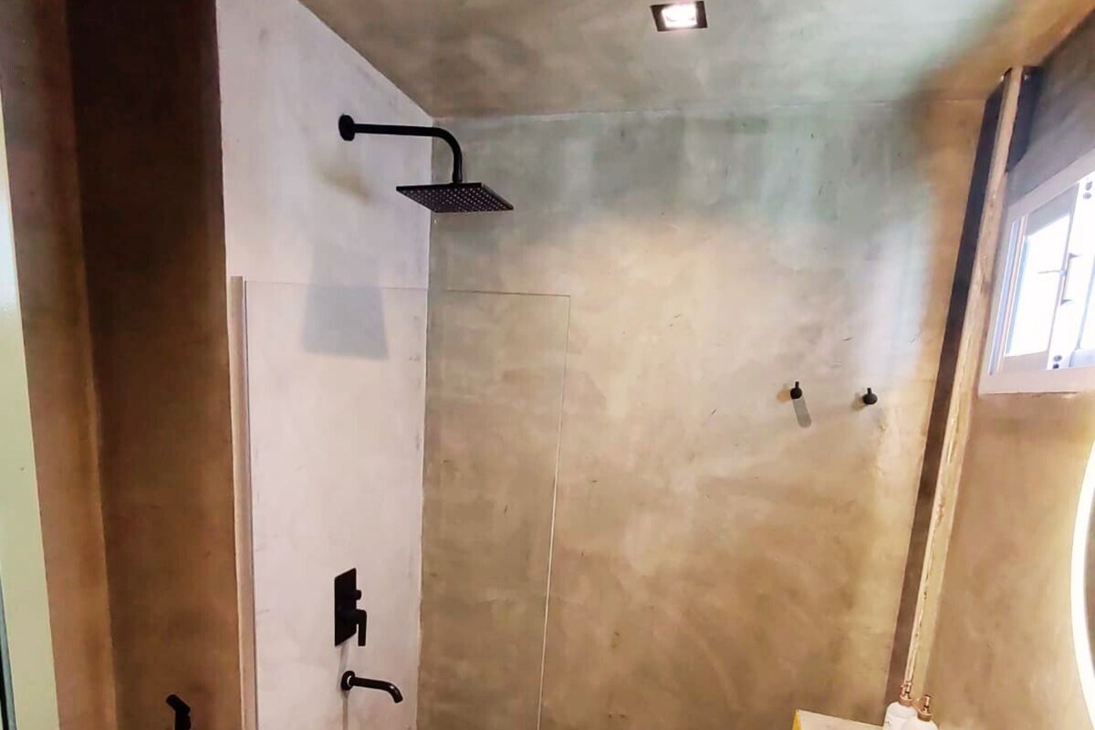 A bathroom with a shower, toilet, and sink.