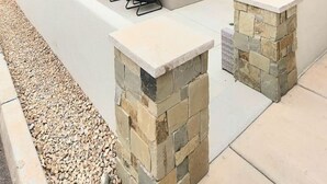 A modern two-story house with a patio area featuring outdoor seating and a stone fireplace. - What a rooftop deck! (Washington)